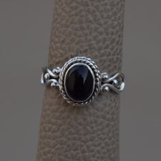 Gemstone-Black Onyx Shape-Oval Metal-925 Sterling Silver This One of a kind ring is adorned with beautiful Black Onyx gemstone in sterling silver.Black Onyx is the birthstone representing the month of December. About gemstone- Black Onyx is the birthstone for Leo. It is the stone of protection.This elegant smooth textured stone is said to have immense healing and spiritual benefits.Black Onyx symbolizes peace,harmony and love and good luck.Black Onyx is well known to remove negativity and act as Black Oval Cabochon Jewelry, Oval Black Cabochon Jewelry, Black Sterling Silver Jewelry With Oval Cabochon, Black Oval Cabochon Sterling Silver Jewelry, Black Oval Cabochon Jewelry For Anniversary, Handmade Oval Onyx Rings, Handmade Oval Onyx Jewelry, Handmade Black Oval Jewelry, Remove Negativity