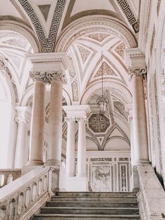 an ornate building with marble stairs and columns