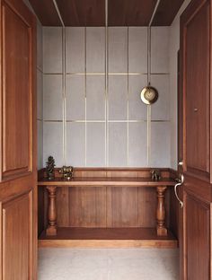 a wooden bench sitting in the middle of a room next to two open doorways