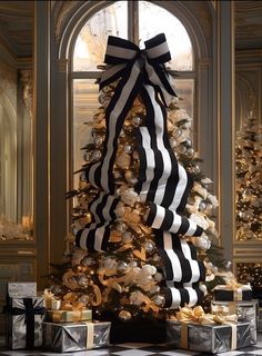 a decorated christmas tree with black and white ribbons