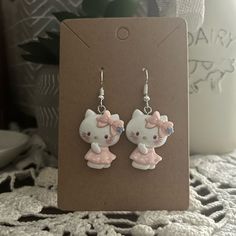 - Adorable Earrings Featuring Hello Kitty - Handmade (By Myself) And Packaged With An Earring Card, Wrapped In A Cellophane Bagperfect For Gifts - Earring Cards Are 6cm (Width) And 9cm (Length) For Size Reference - Charms Are Made Of Resin - These Are Pretty Lightweight - On Silver Fishhook Earring Hooks Colors Are White, Blue, Pink/White Polka Dot Check Out My Closet For More Handmade Jewelry And Other Characters, Including Sanrio Characters Tags: Animal, Forest, Cottagecore, Fairytale, Bear, T Cute White Hello Kitty Jewelry, Trendy White Jewelry With Cute Design, Cute White Jewelry With Cat Design, Cute White Cat Ears Jewelry, Cute White Cat Design Jewelry, Cute Handmade Cat Ears Jewelry, White Cat Design Earrings, Forest Cottagecore, Hello Kitty Earrings