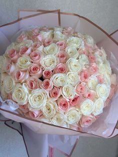 a large bouquet of white and pink roses