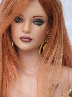 a close up of a doll with long hair and big earrings on it's head