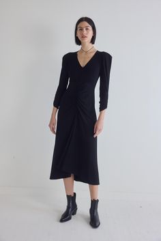 Crafted from high-quality jersey fabric, this dress offers a luxurious feel against your skin, while the stretch ensures a flattering fit that accentuates your curves. The ruched detailing on the dress adds a touch of sophistication, creating a dynamic play of texture that elevates the overall design. Fitted Rouched shoulder and waistline detail V-neck Stretchy fabric Elastane Dress With Ruched Back For Date Night, Date Night Dresses With Ruched Back, Party Ruched Midi Dress In Elastane, Elegant Long Sleeve Dresses With Ruched Sides, Fitted V-neck Midi Dress With Ruched Sides, Midi Length Elastane Dress With Ruched Back, Elegant Elastane Bodycon Dress With Ruched Bodice, Elastane Midi Dress With Ruched Bodice For Night Out, Bodycon Dress With Ruched Bodice In Elastane