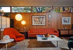 a living room filled with furniture and lots of windows on top of the wall next to each other