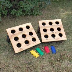 two pieces of wood with holes in them sitting on the grass