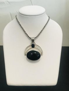 This black onyx pendant and chain is so versatile.  Will go with any outfit, casual or dressy.  Note the beautiful end tabs and clasp on the chain.  Beautifully made.  There is more than 32 grams of sterling solver between both the pendant and chain. Modern Black Oval Pendant Necklace, Black Sterling Silver Necklace With Large Pendant, Black Oval Jewelry With Large Pendant, Sterling Silver Necklace With Large Black Pendant, Black Jewelry With Silver Chain And Round Pendant, Black Necklace With Silver Chain And Round Pendant, Black Onyx Pendant, Double Black, Onyx Pendant