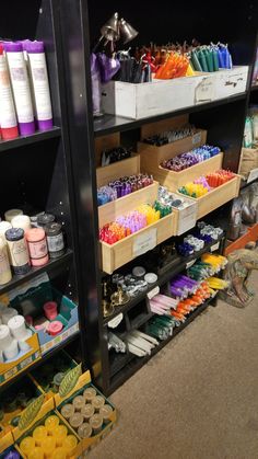 the shelves are filled with many different types of paint and other things to choose from