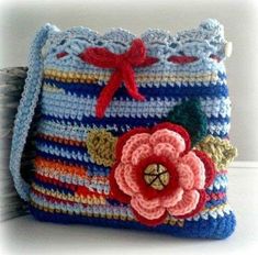 a crocheted purse with a flower on it