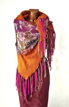 A different shawl, of ethnic inspiration, made with an orange wool blend fabric. In the center, a dark red triangular insert with embroidered flowers and embellished with natural hard stones. The sides are decorated with fuchsia wool and leather fringes. Want to see more scarves? https://www.etsy.com/it/shop/GraffitiTamTam?ref=seller-platform-mcnav&section_id=22530953 ❤️ Remember to add the shop to your favorites to always be updated on news. I invite you to also visit the other shop I manage on Multicolor Fringed Scarves For Festivals, Multicolor Fringe Scarves For Festival, Festival Multicolor Scarves With Fringe, Red Bohemian Shawl With Fringe, Folk Style Handwoven Shawl, Handwoven Folk Shawl One Size, Bohemian Red Pashmina Shawl, Purple Bohemian Scarves For Winter, Multicolor Tassel Shawl For Festival