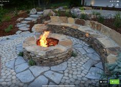 an outdoor fire pit surrounded by stones