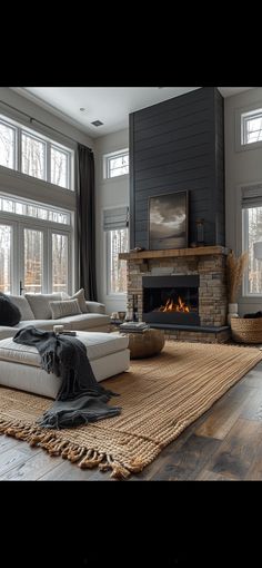 a living room with large windows and a fireplace