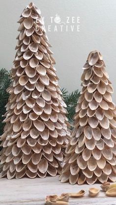 two wooden christmas trees made out of shells