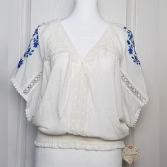 Nwt This V-Neck Dolman Offers Girly Charm With Its Elastic Shirring Waist And Beautiful Blue Embroidered Floral-Accented Flowing Sleeves. White, Large Ptp 22" Length 22" Comment With Questions Bundle For Shipping Savings Offers/Counter-Offers Welcome Spring White V-neck Embroidered Top, White V-neck Embroidered Top For Spring, Spring Wardrobe Essentials, Flowing Sleeves, Overlay Blouse, Light Blue Tie, Lace Trim Blouse, Jacquard Shirt, Women Shirt Top