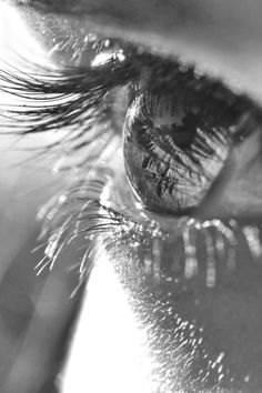 the reflection of someone's eye is shown in this black and white photo,