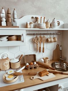 the kitchen counter is cluttered with wooden utensils and other cooking supplies,