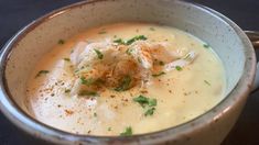 a close up of a bowl of soup with garnishes on the top