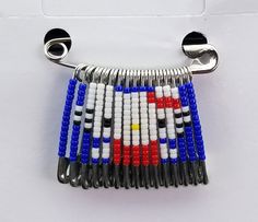 a multi - colored beaded bracelet is hanging from a hook on a white surface