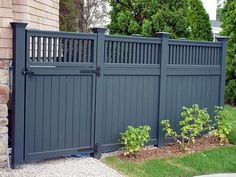 a gray fence in front of a house