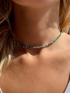 This beautiful gemstone choker made of apatite pearls sparkles in a summery color palette of dark turquoise tones that immediately makes you long for sun and sea. The beads are 2-3 mm in size and faceted. All gemstones are genuine and carefully selected. The clasp is made of brass and is plated with 24k gold, so the necklace will last a long time and will not rub off on the skin. It can also be adjusted by 5 cm. DIMENSIONS & DETAILS 🌴 Material: real apatite beads 🌴 Bead size: 2-3 mm 🌴 Clasp: gold plated with 24k real gold The chain is thin and delicate and available in 2 sizes: 📏 33-38 cm (length) 📏 40-45 cm (length) MANUFACTURING All my jewelry is handmade with love and care in Barcelona (Spain) and Potsdam (Germany). DISCOUNT FOR MULTIPLE ITEMS If you order more than one item, you c Surf Jewelry Necklaces, Turquoise Choker With Round Beads For Summer, Turquoise Beads Choker As A Gift, Turquoise Beads Choker For Gift, Turquoise Choker As Summer Gift, Turquoise Choker For Summer Gift, Adjustable Turquoise Crystal Necklace With Natural Stones, Beaded Turquoise Choker For Gift, Adjustable Turquoise Beaded Necklace With Natural Stones