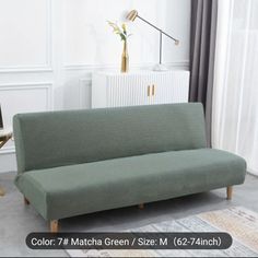 a green couch sitting on top of a rug in a living room