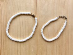 "White puka shell necklace with silver plated screw clasp or lobster clasp in 4 sizes to choose from 14\", 16\", 18\", 20\" . Bright white rounded polished puka beads that measure approximately 1/4\". Now available white puka bracelet (7\") and anklet (10\"). Great addition to your jewelry collection, great gift idea or use it in crafts. Puka shells are gifted to wish good luck to the receiver." White Beaded Bracelets With Lobster Clasp, White Adjustable Beaded Necklace With Lobster Clasp, Adjustable White Beaded Necklace With Lobster Clasp, White Jewelry With Lobster Clasp And Round Beads, White Shell Necklace With Lobster Clasp As Gift, Adjustable Beaded White Shell Necklace, White Bohemian Beaded Bracelets With Lobster Clasp, White Bohemian Bracelet With Lobster Clasp, White Shell Beaded Strand Bracelets