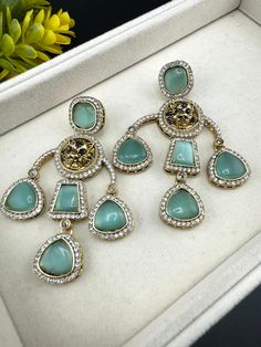 This a beautiful Premium Sabyasachi inspired Mint Green/Light Green colored earring with Monalisa Stone and CZ detailed work. It is a statement earring with stunning designer look which makes it a must to have in your collection. This is so beautiful to look at and a perfect one for Indian weddings.  Color : Light Green/Mint Green, Gold length : 3.5 inch width : 2.25 inch Each earring Weight : 27 grams Material : Brass , CZ, Monalisa Stones Beautiful High Quality, premium jewelry. Free US standa Long Chandelier, Organza Lehenga, Bali Earrings, Gold Chandelier Earrings, Chandbali Earrings, Indian Earrings, White Earrings, Light Weight Earrings, Matching Dresses