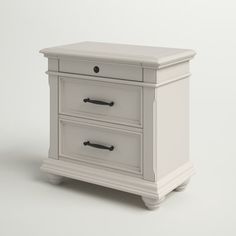 a white nightstand with two drawers sitting on top of it