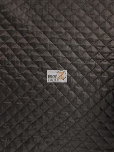 an image of a black quilted material with diamond pattern on it's surface