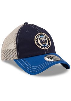 This Philadelphia Union Navy Blue Adjustable Hat features a front embroidered team logo on an unstructured crown with matching visor and contrast soft meshback. New Era Casual Classic Meshback, Front embroidered team logo, 6-panel design with eyelets, Soft contrast meshback, Adjustable Closure, Cotton & polyester blend material, Curved Bill, Low Crown, Unstructured, Imported Blue Hat With Logo Patch And Curved Visor, Blue Hats With Logo Patch And Curved Visor, Blue Curved Visor Hat With Logo Patch, Blue Visor Hat With Logo Patch, Blue Sports Cap With Logo Patch For Baseball Season, Blue Sports Hat With Embroidered Logo, Blue Cotton Trucker Hat For Sports Events, Casual Blue Trucker Hat For Fans, Collegiate Blue Curved Bill Trucker Hat