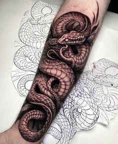 a man's arm with an intricate dragon tattoo on it