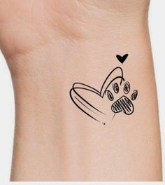 a small tattoo on the back of a woman's neck with a dog paw and heart