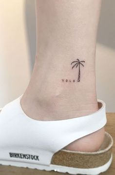 a small palm tree tattoo on the ankle