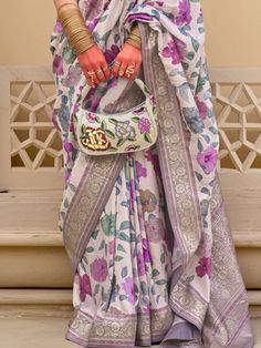 Make a grand entrance at weddings, festivals, and special occasions with our magnetic white floral printed silk festival wear saree with blouse. This stunning ensemble features a white silk saree with intricate floral print work and zari weaving, paired with a vibrant purple silk blouse adorned with matching print work and zari weaving. The 5.50-meter saree and unstitched blouse material allow for customization to ensure the perfect fit for any body type.
The vibrant white color exudes elegance White Silk Saree, Lehenga Crop Top, Lehenga Choli Wedding, Floral Lehenga, Party Wear Lehenga Choli, Reception Gown, Bollywood Lehenga, Cocktail Wear, Party Wear Lehenga