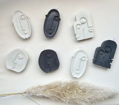 several different shapes and sizes of buttons on a white surface