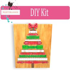 a christmas tree made out of toothbrushes on top of a wooden board with the words diy kit written below it