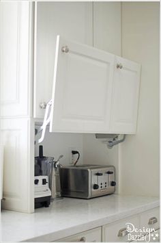 a toaster oven sitting on top of a kitchen counter next to a microwave and toaster