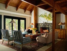 a living room filled with furniture and a fire place in the middle of a room