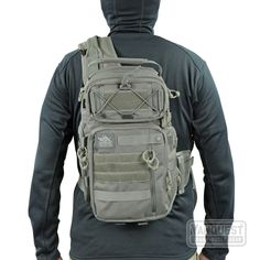 a man wearing a gray backpack with the hood up and his back turned to the camera