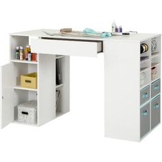 a white desk with drawers underneath it and some items on the shelf above it that is open