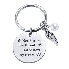 a keychain that says not sisters by blood but sisters by heart with an angel charm