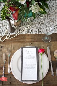 a table setting with flowers and silverware