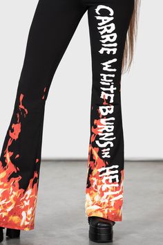 CARRIE.- Official licensed Carrie 1976 product.- Soft, stretch fabric.- Statement flame print.- Text reads "Carrie white burns in hell!"- Elasticated waistband.- Boot cut.- High waisted.- Fitted.With KILLSTAR branding, 94% Cotton, 6% Elastane.Machine wash cold (30°c) / Do not bleach / Do not tumble dry / Iron at low temperature / Do not dry clean.TM & © 2023 MGM Fitted Cotton Bottoms With All Over Print, Flare Cotton Pants For Streetwear, White Retro Pants For Streetwear, Spring Streetwear Bottoms With Logo Print, Stretch Cotton Bottoms With Graphic Print, Fitted Graphic Print Pants For Streetwear, White Graffiti Print Bottoms For Streetwear, Fitted Pants With Graphic Print For Streetwear, Fitted White Graphic Print Pants