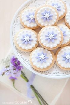 cookies decorated with blue and white flowers on a plate