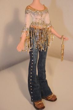 a doll dressed in jeans and beaded clothing