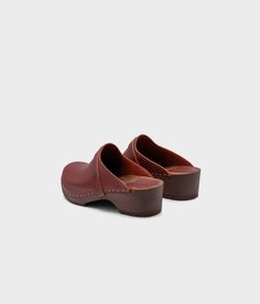 The best clogs for all occasions. Stylish with a nod to the past and an eye towards the future. With a handcrafted design, versatile colors, and comfortable wooden soles, these classic wooden clog mules will last you for years to come. Clog measurements:Heel height: 1 3/4” (4.5 cm)Toe height: 1 5/8″ (4.1 cm)Fit:RegularLeather:Vegetable tanned leatherClogs consist of:Base: European Lime WoodSole: Rubber soleFastening: Staples Clog Mules, Cork Sandals, Wooden Clogs, Clog Sandals, An Eye, Boot Shop, Mule, Cognac, Clogs