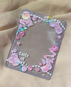 a glass plate with pink flowers and butterflies on it that says taste of love in the center