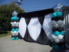 an outdoor event with balloons and streamers