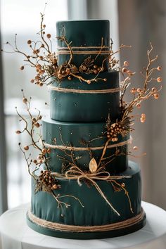 a three tiered green wedding cake with gold accents