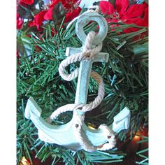 an anchor ornament hanging from a christmas tree